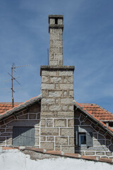 stone wall of house facade with chimneys