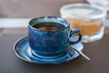 cup of black coffee in morning in cafe. Black coffee at business lunch against  backdrop of basket of toasted bread and cane sugar. Good morning energy, motivation concept. selective focus