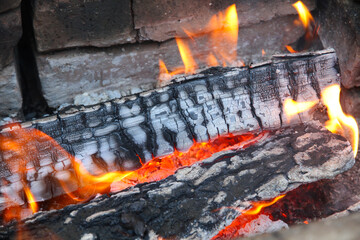 Glowing embers in hot red color, abstract background. The hot embers of burning wood log fire....