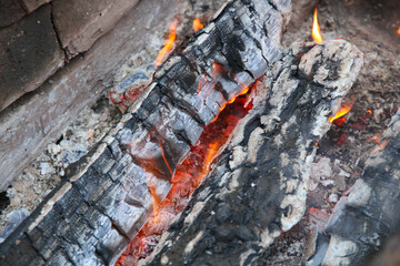 Glowing embers in hot red color, abstract background. The hot embers of burning wood log fire....