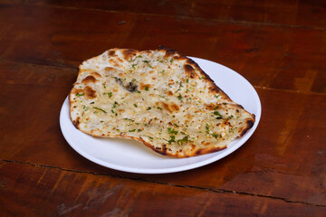 Homemade Indian Naan Flat bread made with Whole Wheat.on wooden table stock photo.
