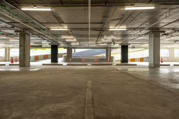 Empty cement Parking Garage interior and exit sign Arrow sign in parking garage interior Industrial building or Supermarket