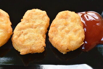 fried chiken nugget meat dipping ketchup on plate