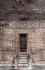 Badami, Karnataka, India - November 7, 2013: Cave temples above Agasthya Lake. Portrait of steps and door into empty sanctum at cave 3.