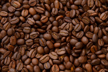 Fototapeta premium Roasted coffee beans heap isolated on white background can be used as background