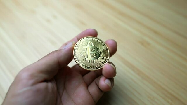 Bitcoin (btc, xtc) coin top most value cryptocurrency in people hand. Money business and finacial investment concept photo. 4K footage.