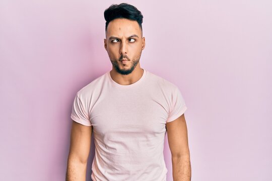 Young arab man wearing casual clothes making fish face with lips, crazy and comical gesture. funny expression.