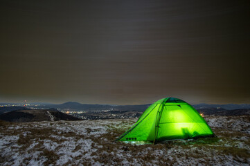 Tent on the trails of the stars in winter on the mountain