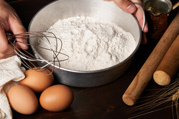 hand working with bakery and cooking bread pastry or cake ingredients in wooden table background. homemade                                                                                             
