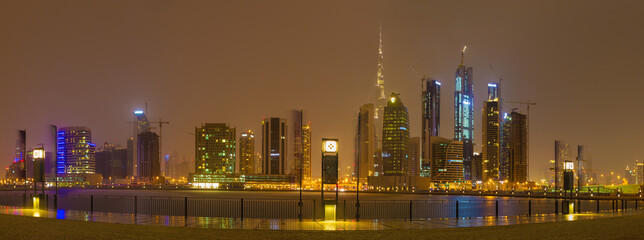 DUBAI, UAE - MARCH 24, 2017: The evening skyline over the Canal and Downtown in rain.