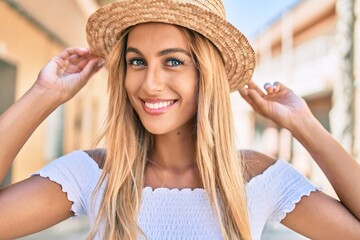 Young blonde tourist girl smiling happy walking at the city.