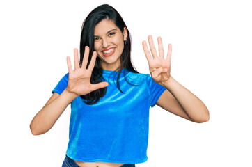 Young hispanic woman wearing casual clothes showing and pointing up with fingers number nine while...