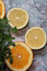 Naklejka na ściany i meble lemon and orange slices on a marbled background, fresh juicy sliced fruit, citrus