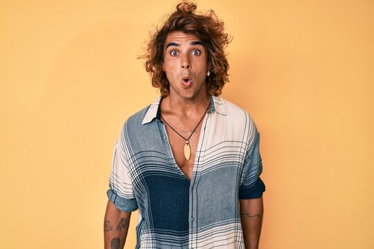 Young hispanic man wearing summer style scared and amazed with open mouth for surprise, disbelief face