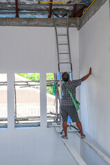 Electrician male working install wire power cable . professional technician worker climb for wire electric in new house.