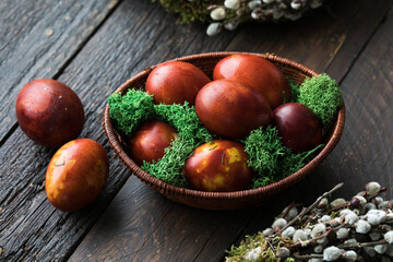 Painted Easter eggs in onion husks with abstract drawings are in a basket