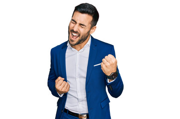 Young hispanic man wearing business jacket celebrating surprised and amazed for success with arms...