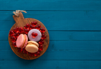 Small French cakes. Sweet and colorful French macarons cakes. Top view. A gift for Valentine's Day. Copy space