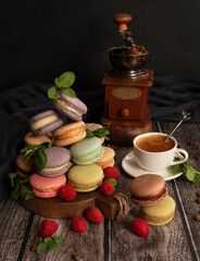 Colorful macarons. Small French cakes. Sweet and colorful French macaroni cakes on a wooden table.