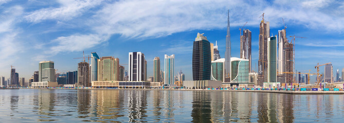 Fototapeta na wymiar DUBAI, UAE - MARCH 29, 2017: The skyline with the bridge over the new Canal and Downtown and Burj Khalifa tower.