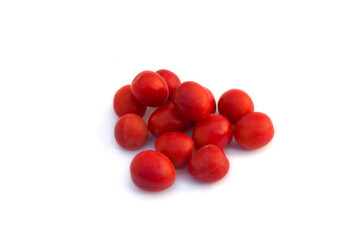 Group of red wild cherry plums in the glass vase isolated on the white background.