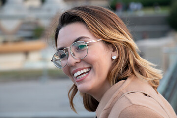 Closed up of a sophisticated woman smiles and enjoys the views of the city of Barcelona