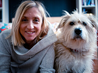 Beautiful image of woman posing with her dog at home