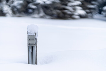 Snow covered engine block heater a parking lot in middle of a snow storm