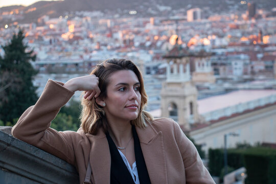 Closed up of a sophisticated woman smiles and enjoys the views of the city of Barcelona