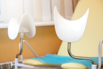 gynecological chair in gynecological office on orange background. Health checkup. Women's Health Concept