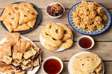 Traditional Tatar Cuisine On Wooden Table. Kystybyi, Echpochmak, Peremech, Chak Chak, Belesh, Tea In Piala, Dried Fruits And Nuts. Top View.