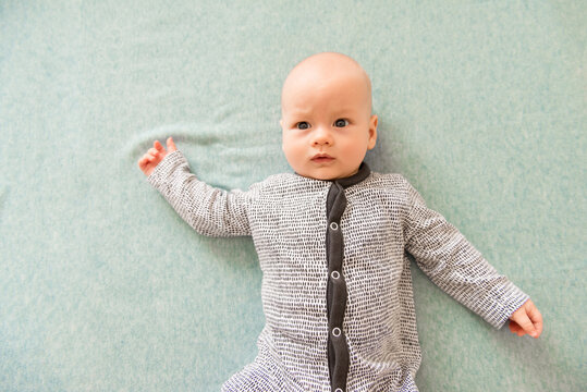 Cute scared baby on blue background. Concept for articles about childhood or advertising for babies