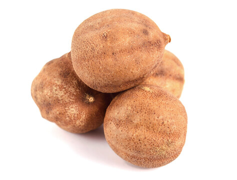 Sun Dried Lime. Dry Lemon (Limu Omani) Isolated on White Background. Also known as Black Lime, Noomi Basra, Limoo Amani and Loomi.