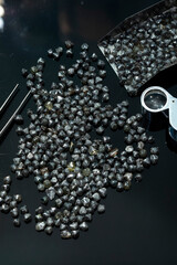 Natural Rough diamonds on black background sorted by size and shapes . High quality photoNatural 