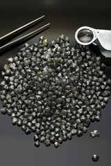 Natural Rough diamonds on black background sorted by size and shapes . High quality photoNatural 