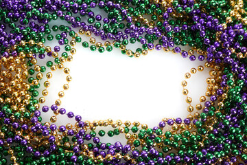 A frame of three colors of Mardi gras beads on white background