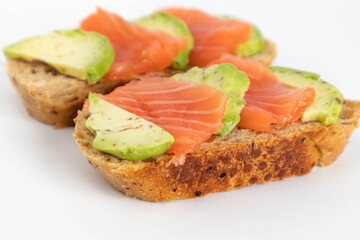 Homemade Toast sandwich with Salmon, Avocado on on a slice of grain bread. healthy food
