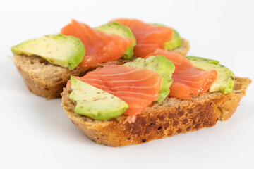 Homemade Toast sandwich with Salmon, Avocado on on a slice of grain bread. healthy food