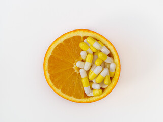Natural vitamins. Health and immunity. Vitamin C in a half of an orange on a white background, top view, flat lay