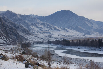 Fototapeta premium Snow covered mountains and iced river
