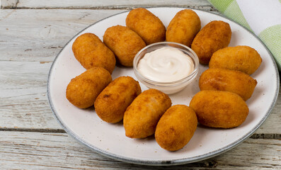 Chicken croquettes with mayonnaise sauce served on a plate