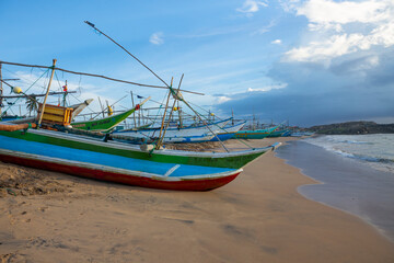 Naklejka na ściany i meble Fishing boats on the beach in Galle of Sri Lanka.