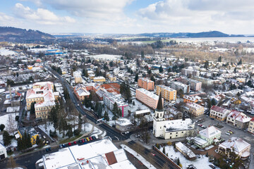 Obraz premium Aerial view of a small town in winter covered in snow