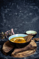 Pumpkin soup on wooden board with negative space