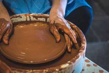 Pottery workshop, where it is shown how the master makes a plate from clay