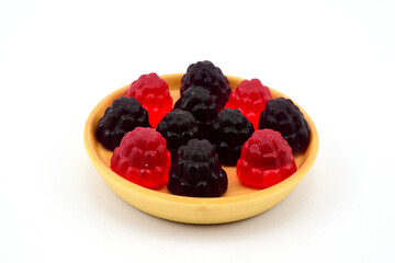 Blackberry-shaped marmalade candies laid out on a wooden plate