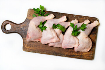 Raw chicken thighs on a wooden board