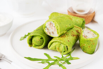 Homemade green vegetarian pancakes with filling ( potatoes and mushrooms), vegetable food, spinach pancakes