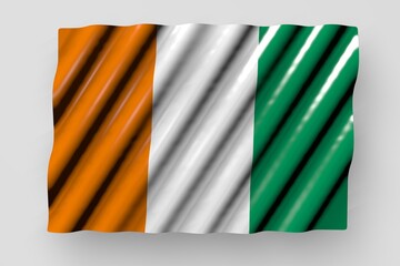 beautiful shiny flag of Cote d Ivoire with big folds lay isolated on grey - any feast flag 3d illustration..