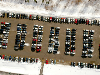 Car parking lot at winter viewed from above. Bird eye aerial view. Canada.